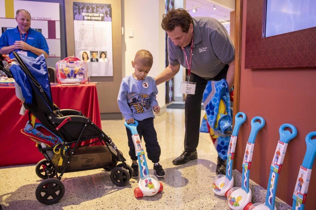 Window world employee giving gifts to local children